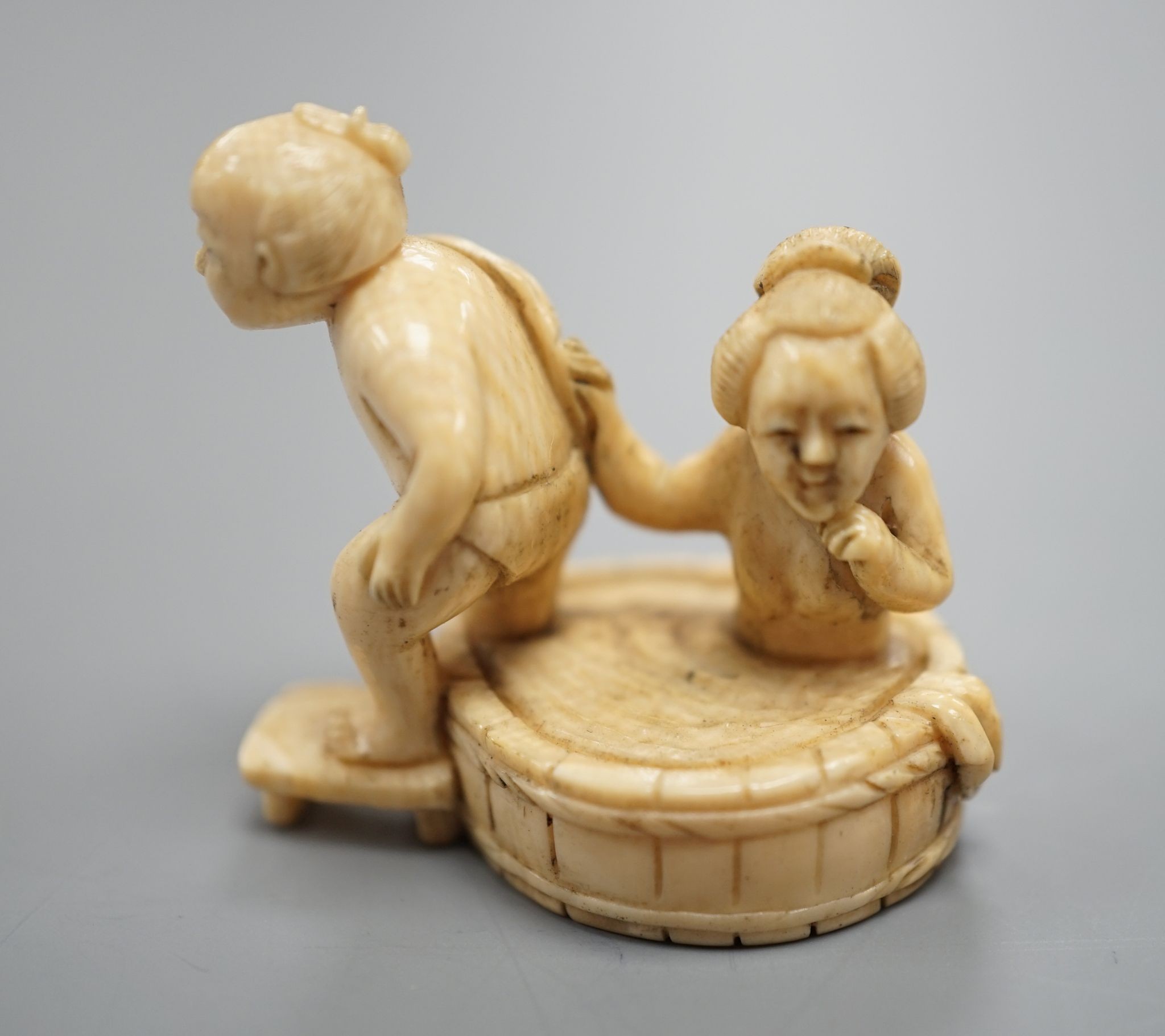 A Japanese ivory Netsuke of a bathing couple, Meiji period, 3.5 cms high.